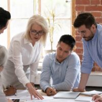 business woman teaching group of men