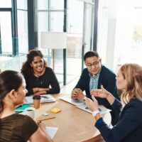Group of people around table having meeting