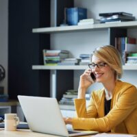 Lady on phone in front of laptop