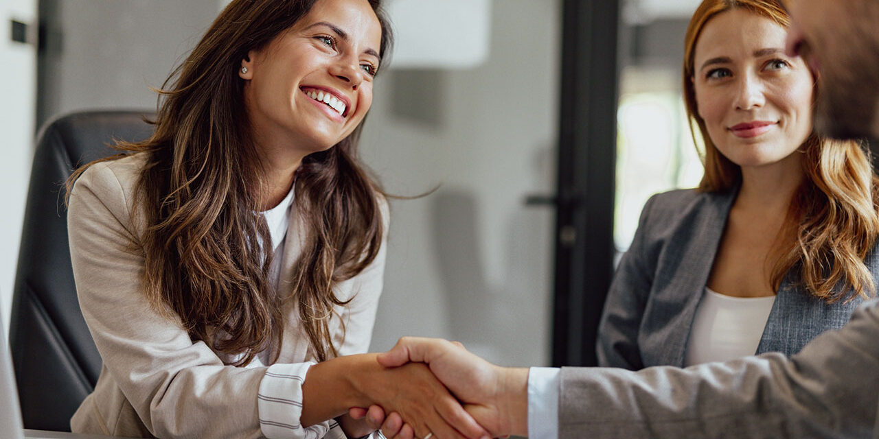 Woman in business meeting shaking hands